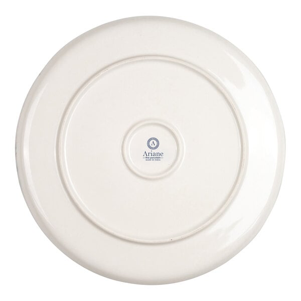 The image shows the underside of a round, ivory-colored porcelain plate with a small central logo and text.