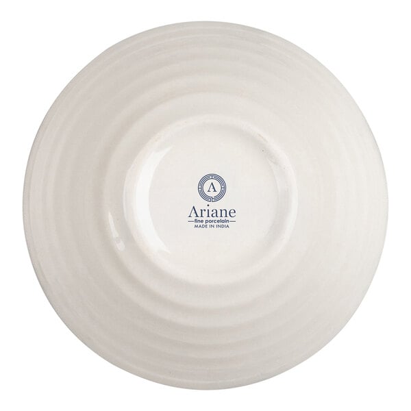 The image shows the underside of a round, ivory-colored porcelain bowl with concentric ridges and a logo that reads 'Ariane Fine Porcelain Made in India' in the center.