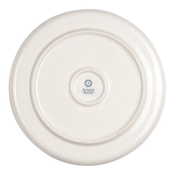 The image shows the underside of a round, ivory-colored porcelain plate with a small central logo and text.