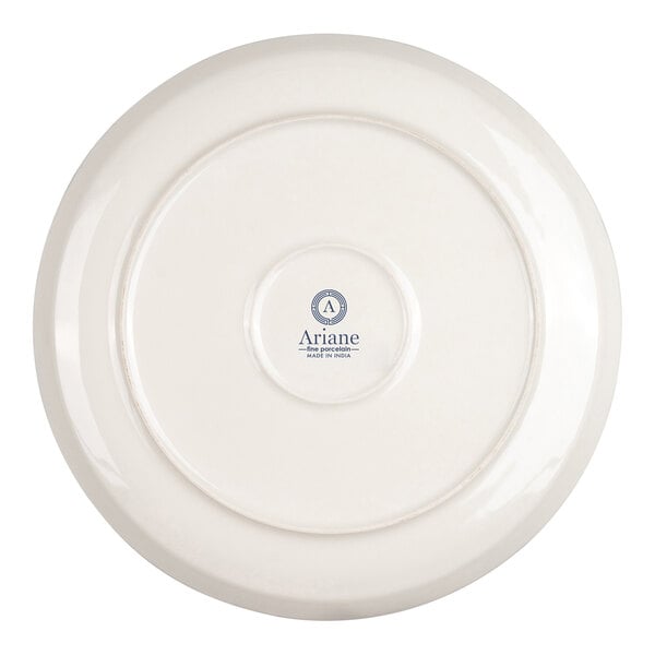 The image shows the underside of a round, ivory-colored porcelain plate with a central logo and text.