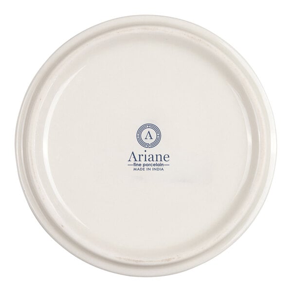 The image shows the underside of a round, ivory-colored porcelain dish with the brand name 'Ariane' and 'Made in India' printed in blue at the center.