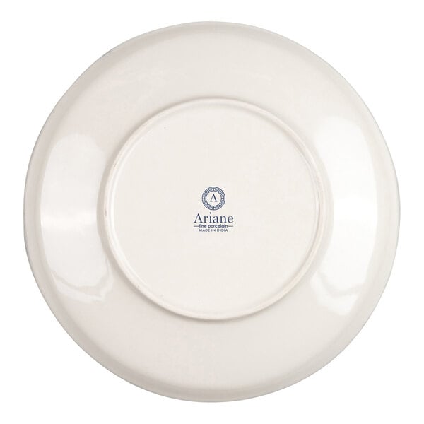 The image shows the underside of a round, ivory-colored porcelain bowl with a logo and text printed in the center.