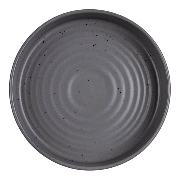A round, gray bowl with a ridged texture and small black speckles on its surface.