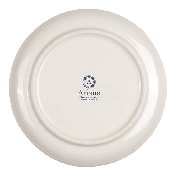 The image shows the underside of a round, ivory-colored porcelain plate with a logo and text indicating it is made by Ariane in India.
