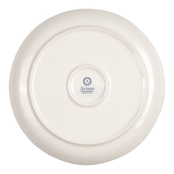 The image shows the underside of a round, ivory-colored porcelain plate with a small logo and text in the center.