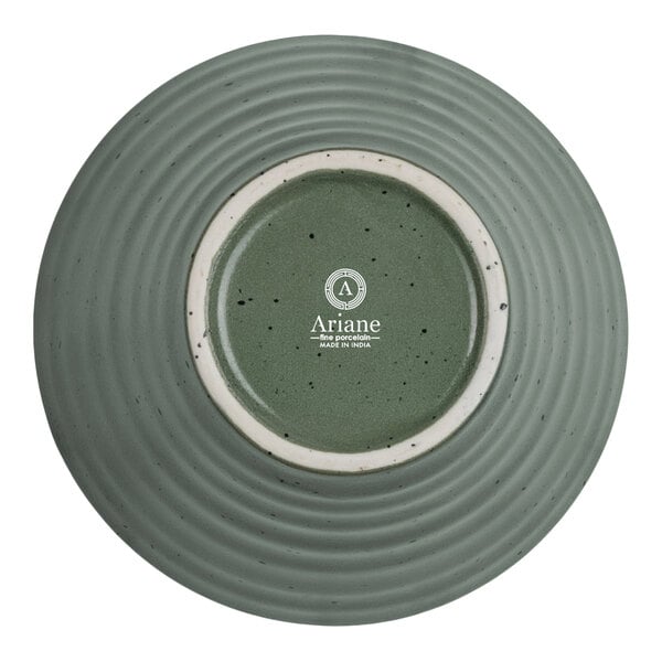 A round, green, ribbed porcelain bowl shown upside down with a speckled pattern and a white circular base.