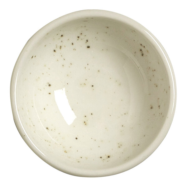A small, round, white bowl with a glossy finish and subtle dark speckles on its surface.