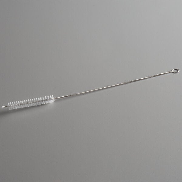 A long, thin brush with white bristles and a twisted metal handle, featuring a loop at one end.