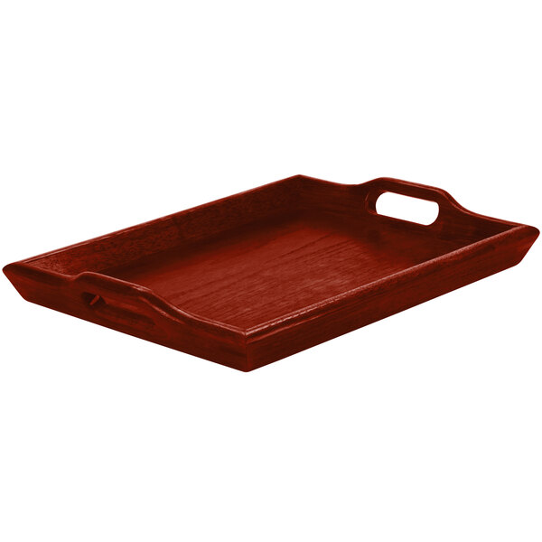 A rectangular wooden tray with raised edges and cut-out handles on the shorter sides, finished in a dark mahogany color.