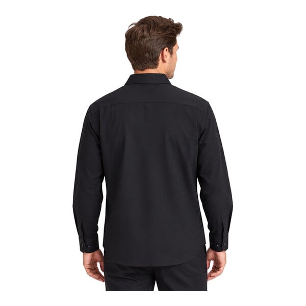 A man is shown from the back wearing a long-sleeve black dress shirt and black pants.