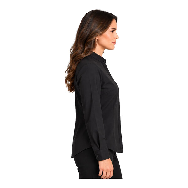 A woman is shown in profile wearing a long-sleeve black shirt and black pants against a white background.