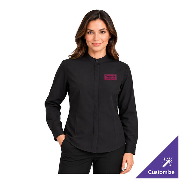 A woman is wearing a black long-sleeve shirt with a banded collar and a small embroidered logo on the left chest.