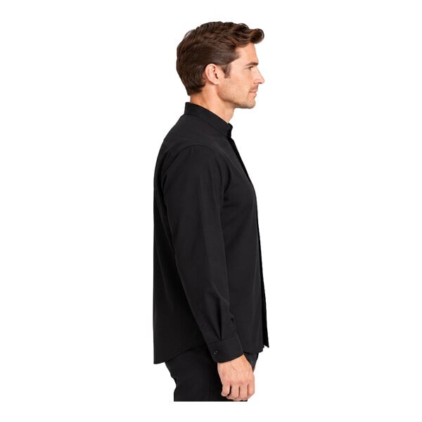 A man is shown in profile wearing a long-sleeve black dress shirt with a banded collar.