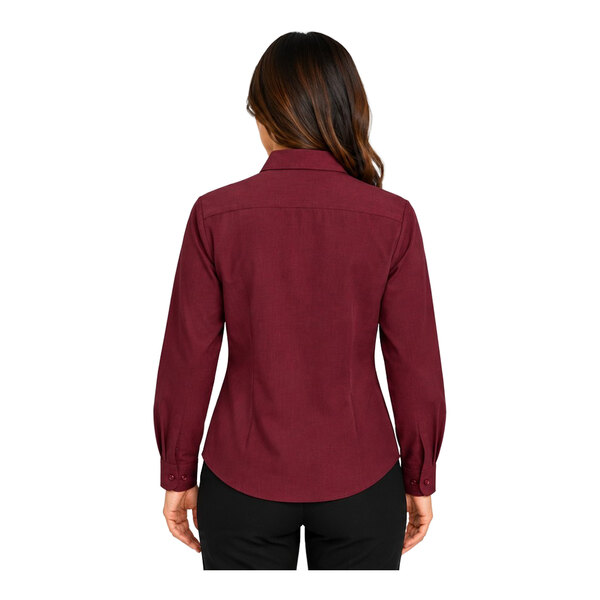 A woman is shown from the back wearing a long-sleeve, burgundy button-up shirt and black pants.