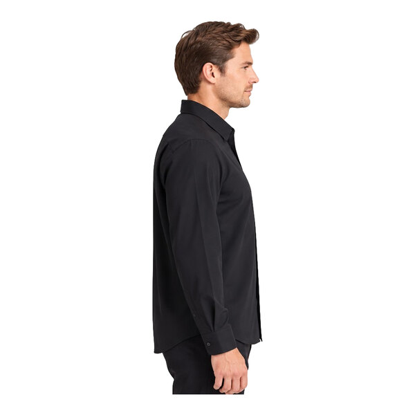 A man is shown in profile wearing a black long-sleeve button-up shirt and black pants against a white background.