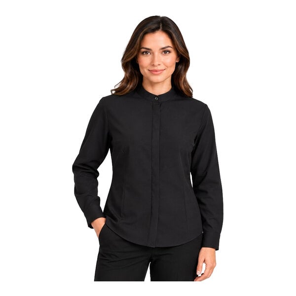A woman is wearing a long-sleeve black shirt with a banded collar and concealed buttons.