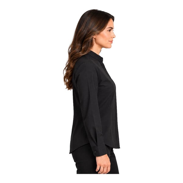 A woman is shown in profile wearing a long-sleeve black shirt and black pants against a white background.