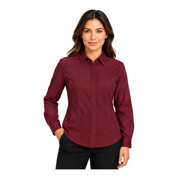 A woman is wearing a long-sleeve, burgundy button-up shirt with a collar and black pants.
