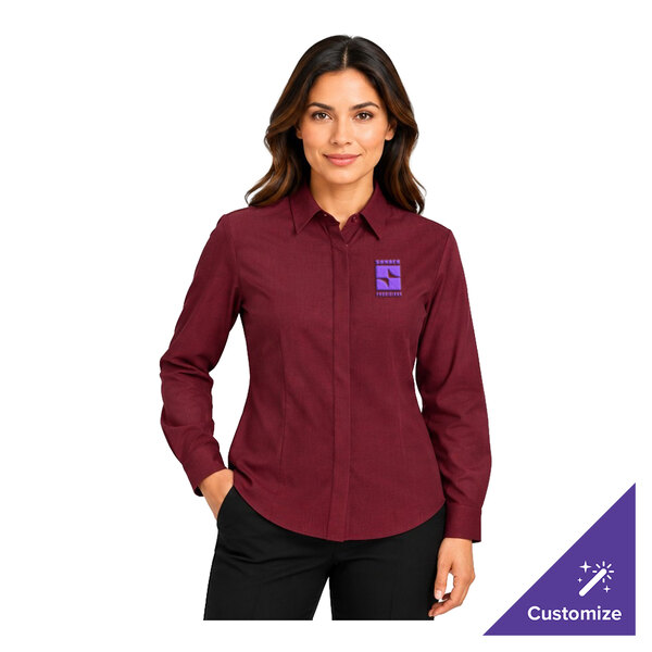 A woman is wearing a long-sleeve, burgundy button-up shirt with a collar and a small purple logo on the left chest.
