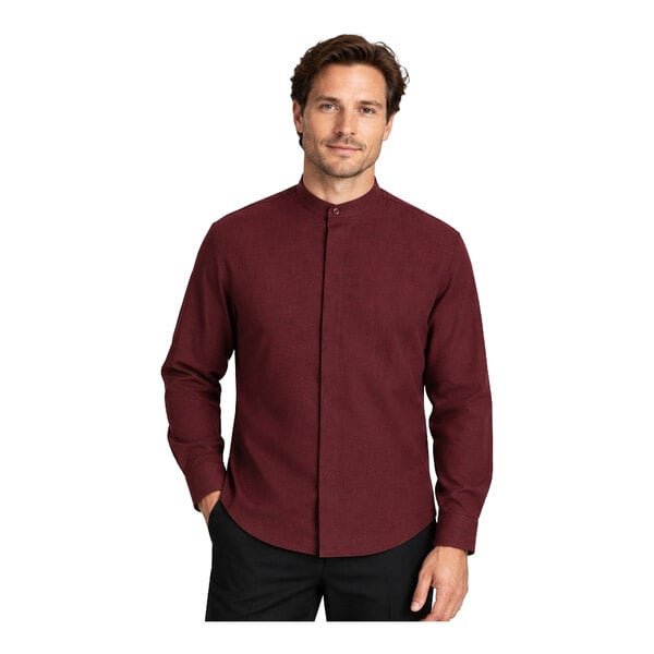 A man is wearing a long-sleeve, burgundy dress shirt with a banded collar and black pants.
