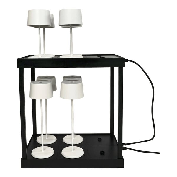 A black rectangular charging platform with six white lamps placed on it, connected by a power cord.