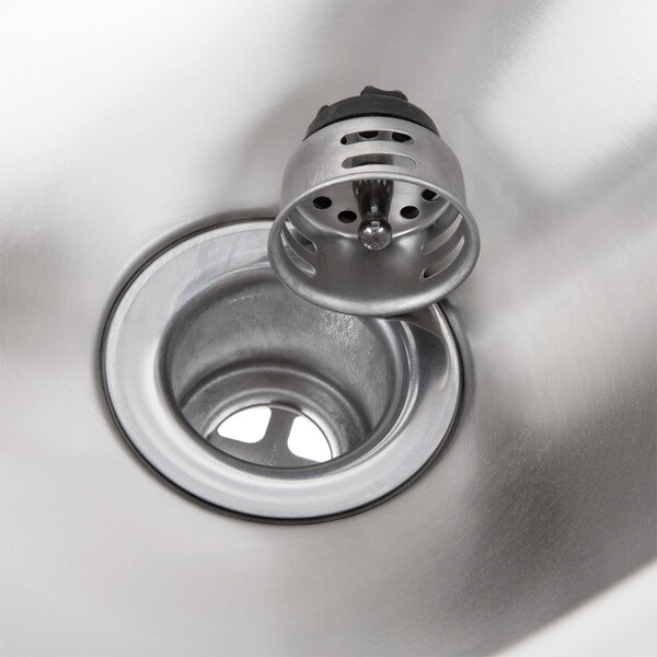 A close-up of an Eagle Group stainless steel wall mount hand sink with a basket drain.