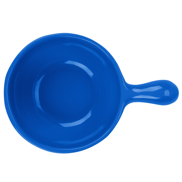 A Tablecraft cobalt blue cast aluminum bowl with a handle.