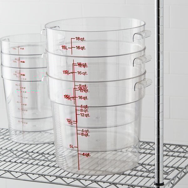 A stack of Cambro clear plastic round food storage containers.