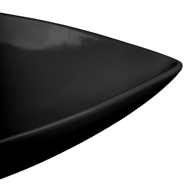 A close-up of a black Tablecraft cast aluminum triangle display bowl with curved edges.