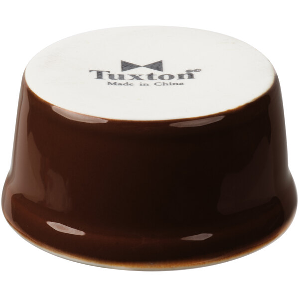 A brown and white ceramic Tuxton ramekin.
