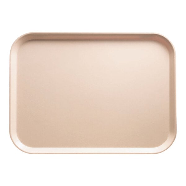 A rectangular light peach Cambro tray on a counter.