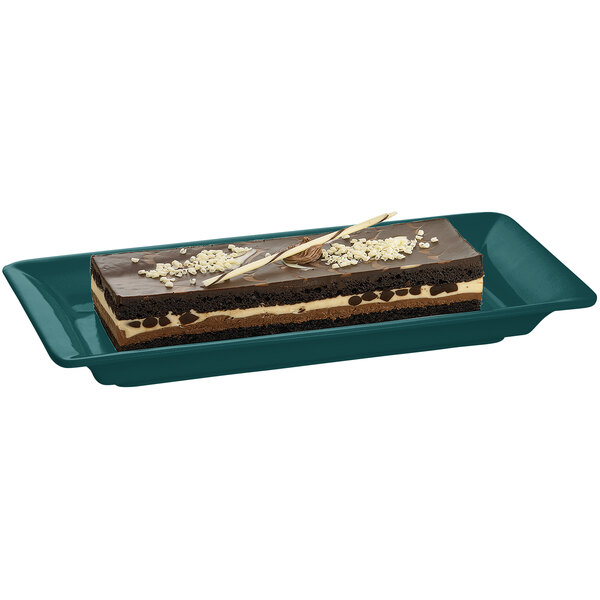 A Tablecraft hunter green rectangular metal serving platter with a piece of chocolate cake on it.