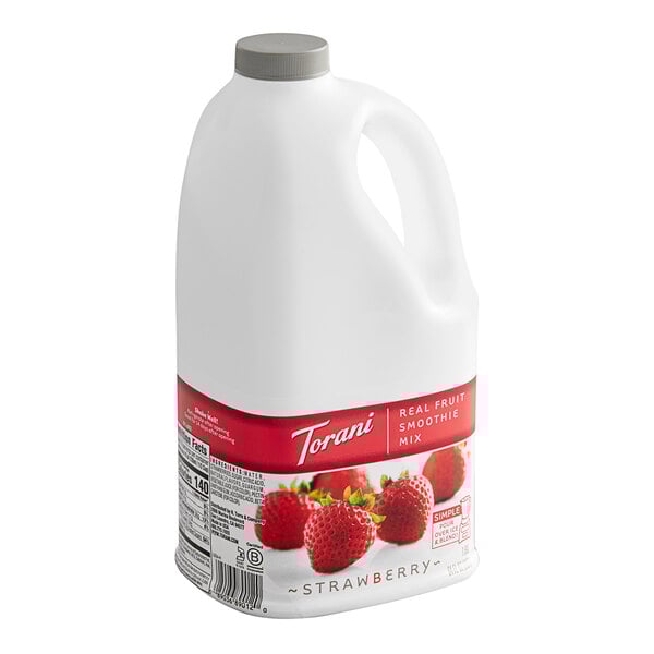A white jug of Torani Strawberry Fruit Smoothie Mix.