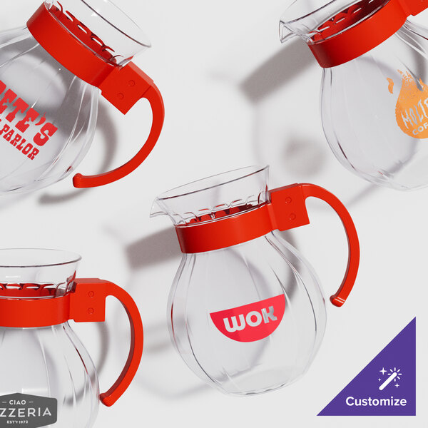 A clear glass pitcher with a red handle.