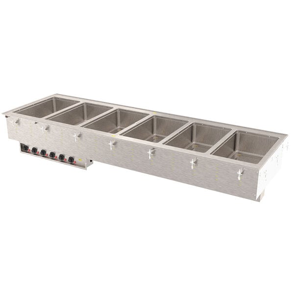 A Vollrath drop-in hot food well with four compartments in a stainless steel container on a counter.