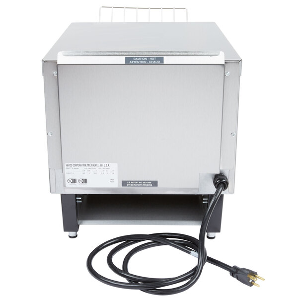 A close-up of a Hatco Toast Qwik conveyor toaster with a cord.