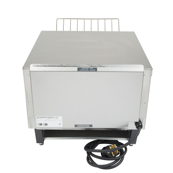 A white and silver Hatco Toast Qwik conveyor toaster with a cord.
