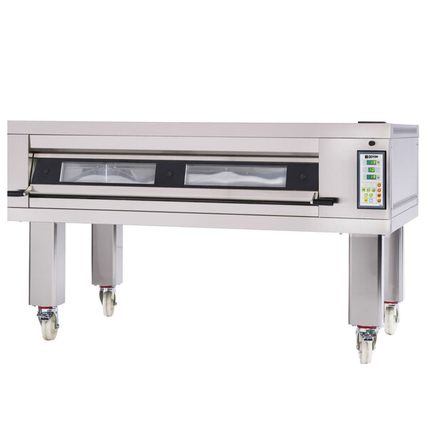 A large metal Doyon deck oven with a stone surface and three doors.