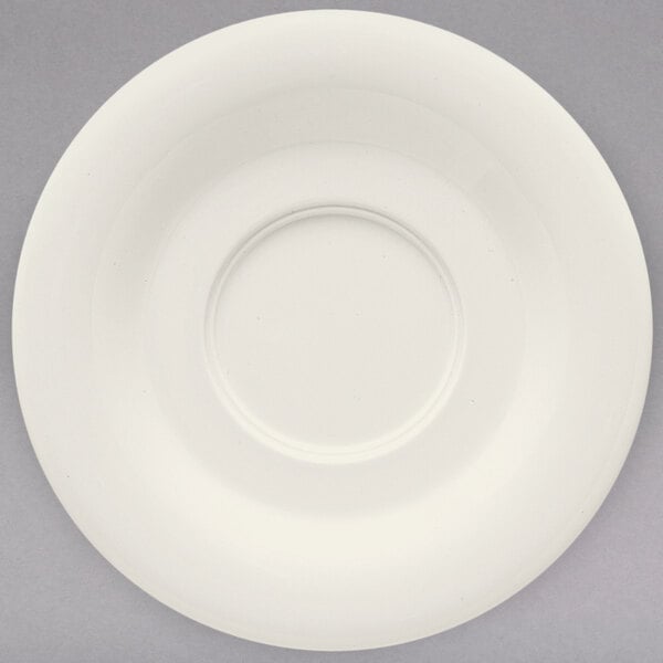 A white saucer with a rim.