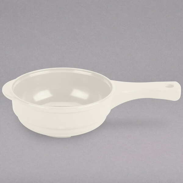 An ivory melamine bowl with a handle.