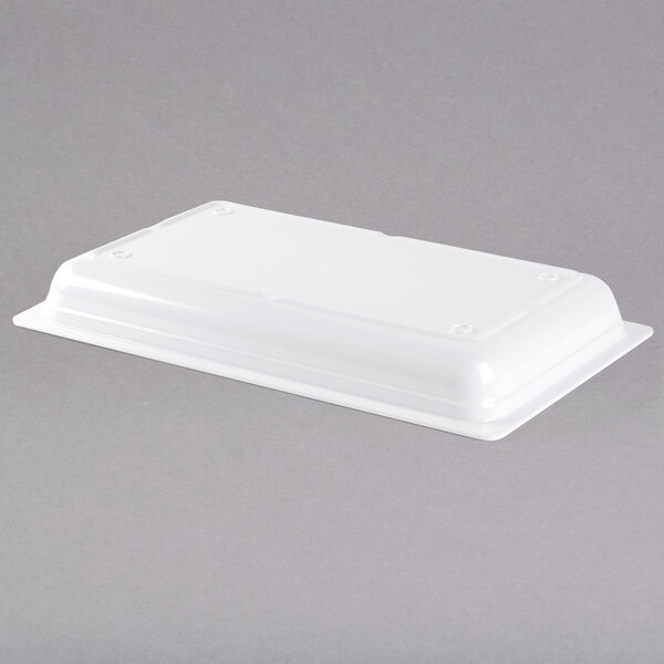 A white rectangular GET Melamine food pan on a gray surface.