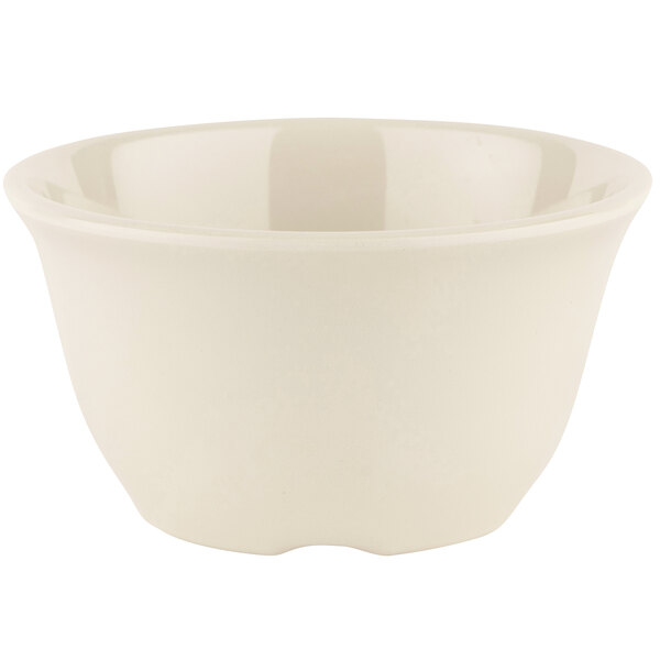 A GET Diamond Ivory melamine bowl with a curved edge on a white background.