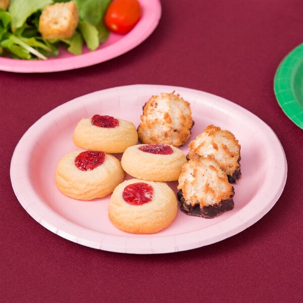 A Classic Pink Creative Converting paper plate with cookies and salad on it.