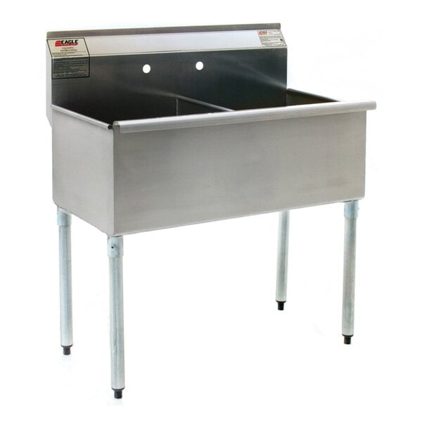 A Eagle Group stainless steel commercial sink with two drainboards on legs.