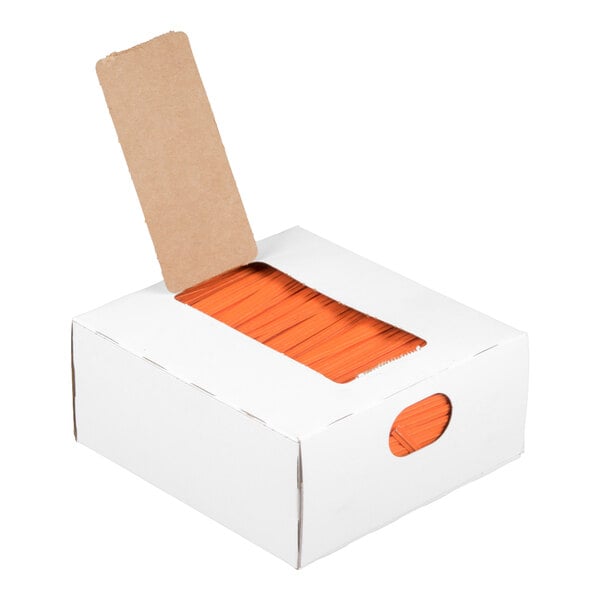 A white cardboard box with an open flap revealing a stack of orange twist ties inside.