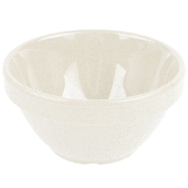 A close-up of a white bowl with a speckled surface.