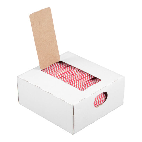 A white box with a rectangular opening on top, showing a roll of red and white striped twist ties inside, and a single twist tie partially pulled out.