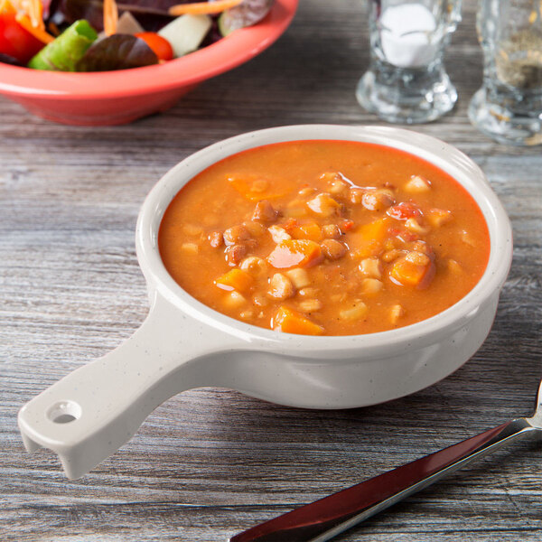 A Santa Fe ironstone bowl filled with soup on a table.