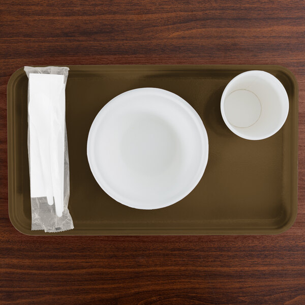 A rectangular brown Cambro tray with a bowl and a cup on it.