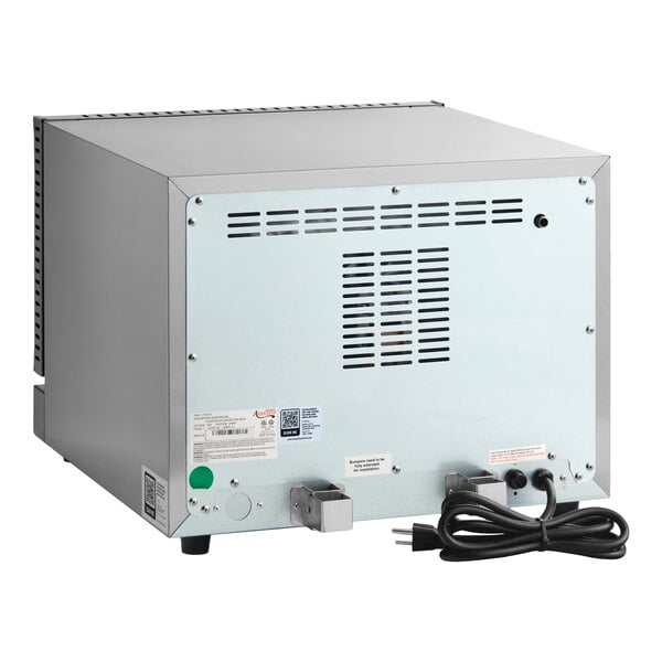 The image shows the back view of a stainless steel countertop appliance with ventilation slots, labels, and a power cord.